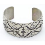 A North American bangle formed bracelet with incised geometric decoration. Marked Sterling Please