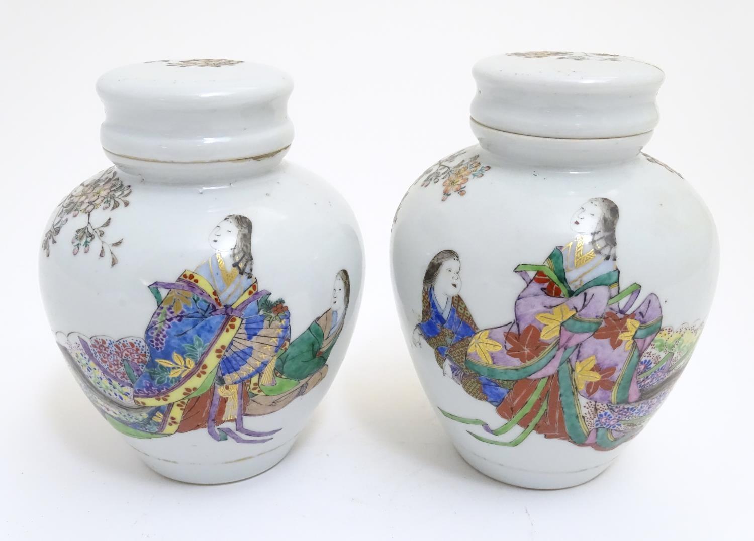 A pair of Oriental spice jars with lids and covers with hand painted decoration depicting two female