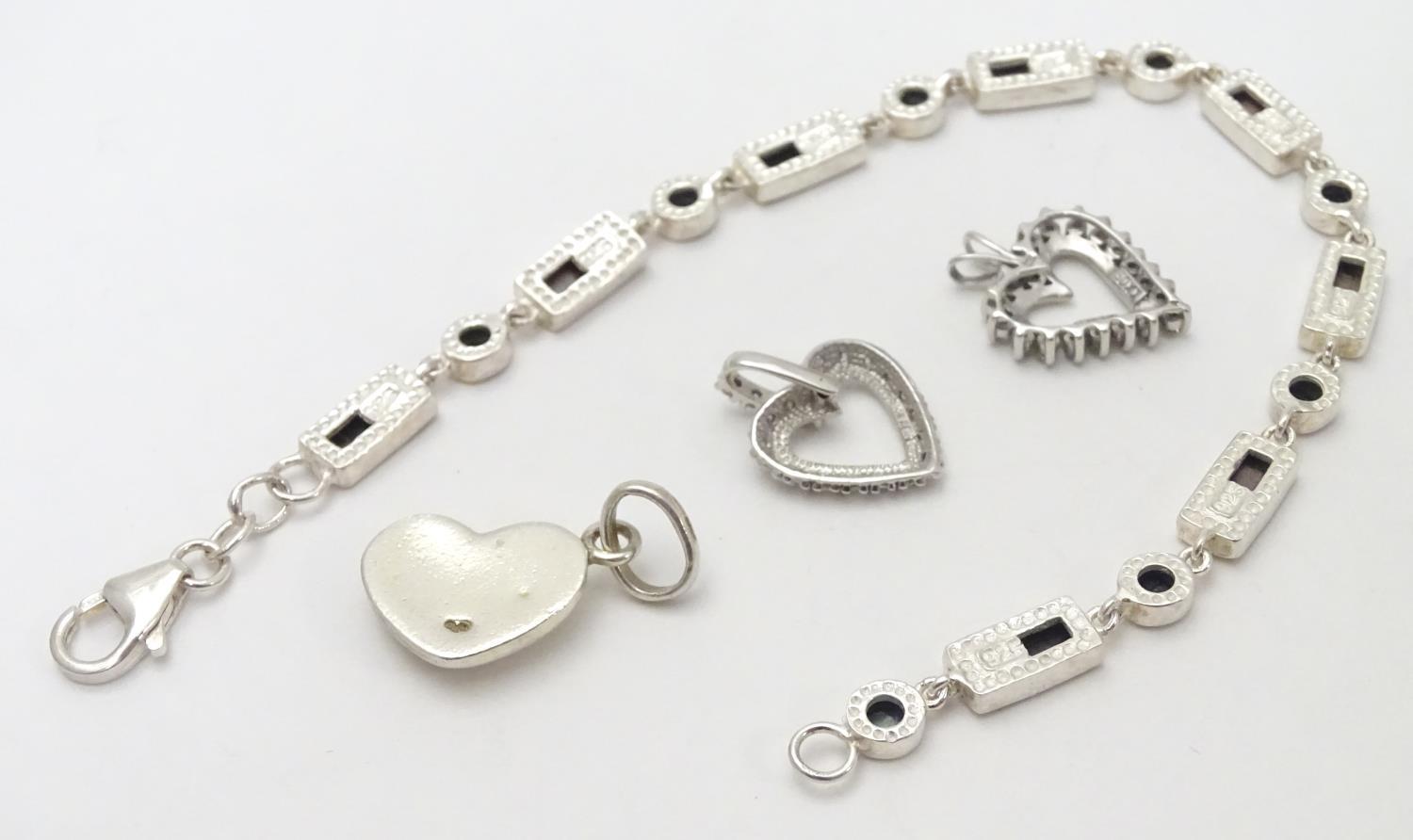 A silver bracelet set with abalone shell detail together with and 3 assorted charms (4) Please - Image 5 of 8