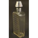 A glass medicine flask / decanter with cut horizontal measure marks to back. With silver mount and