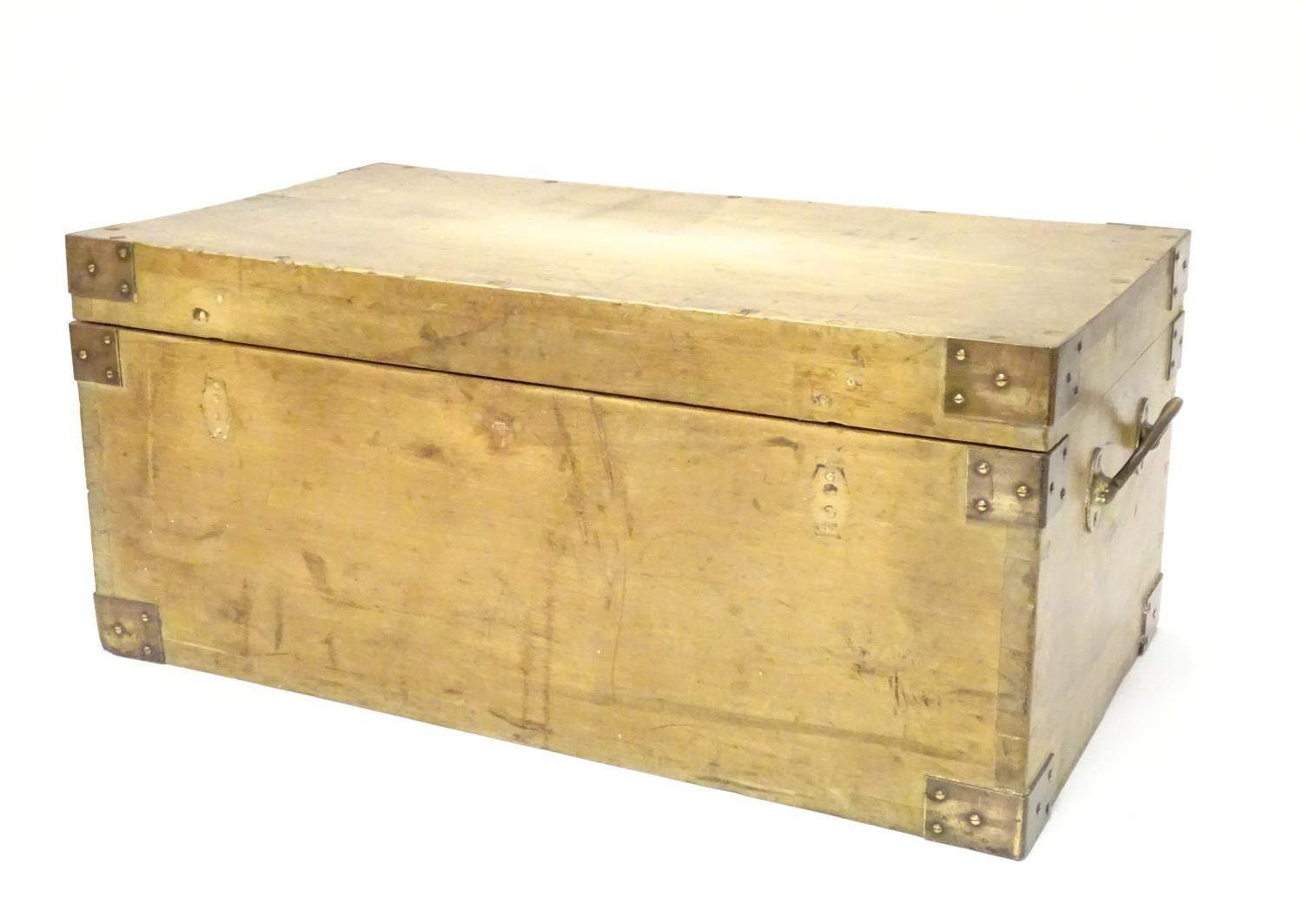 An early to mid 20thC hardwood box with brass carrying handles and brass mounts to the corners