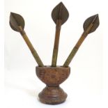 Three naive 20thC oversized darts with associated carved wooden base with chip carved detail.