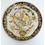 A Copeland plate decorated with flower and foliage with a bird in a cage with cobalt blue and gilt