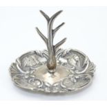 A silver ring tree, the base with winged cherub decoration. Hallmarked Birmingham 1906 maker Henry