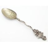 A silver souvenir spoon, the leaf surrounded handle surmounted by a bust of William Shakespeare over