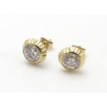 A pair of 9ct gold stud earrings set with paste stones. Approx. 1/4" diameter Please Note - we do
