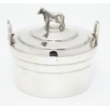 A silver plate butter dish of circular form with glass liner, the lid with cow formed finial. 4"
