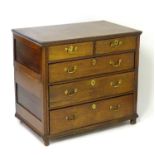 An 18thC oak chest of drawers with a moulded top above two short over three long graduated drawers