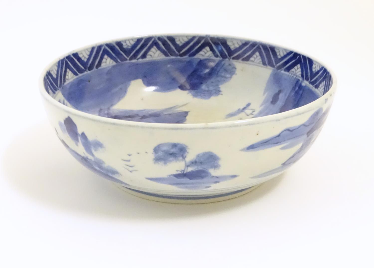 A Chinese blue and white bowl with hand painted decoration depicting an Oriental landscape with - Image 5 of 10