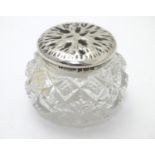 A cut glass pot with silver lid with textured decoration to top. Hallmarked Birmingham 1902 maker