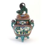 A Chinese pot and cover of koro form, the cover surmounted by a foo dog. The body decorated with a