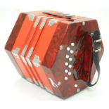 Musical Instrument: a late-20thC Concertina, in red finish with flight case, approximately 9" wide
