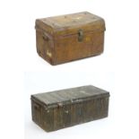 Two late 19thC tin trunks with lifting lids and flanked by carrying handles. The largest measuring