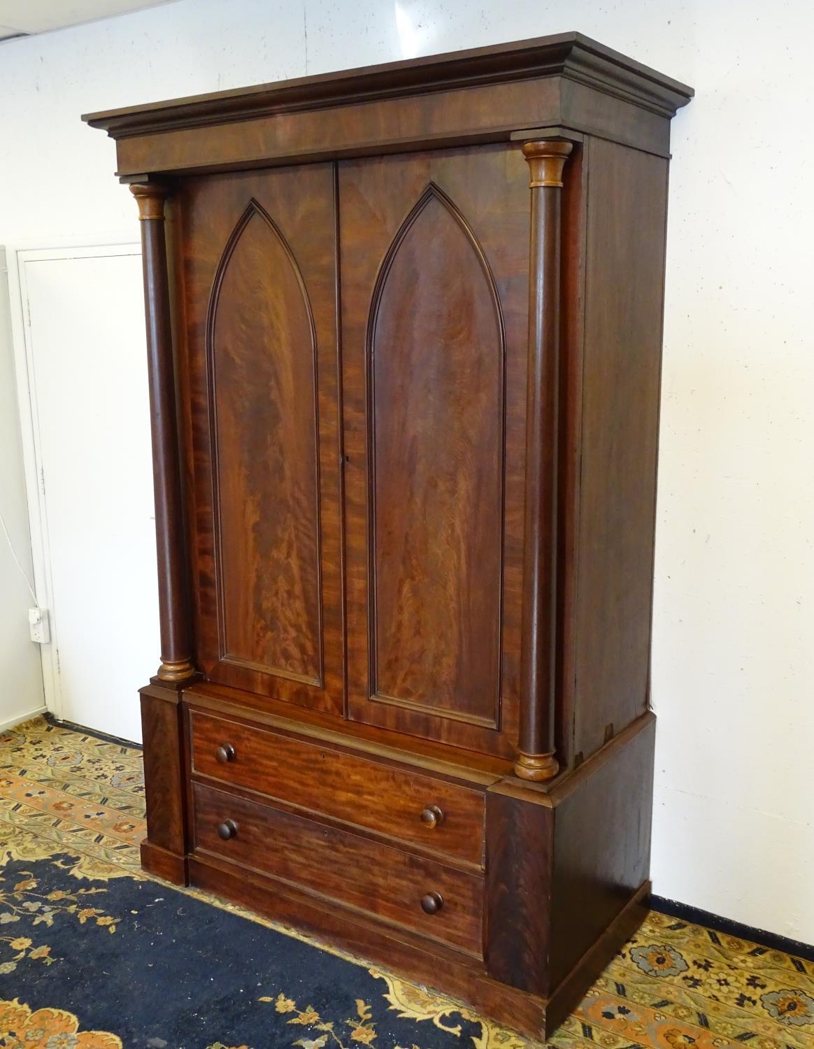 A 19thC mahogany press with a moulded cornice above two large doors with lancet shaped panelling, - Bild 5 aus 7