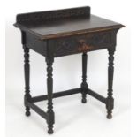 A late 19thC oak side table with a shape upstand above a moulded top and frieze drawer with carved