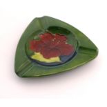 A Moorcroft green ground pin dish / ashtray of triangular form in the Hibiscus pattern. Impressed