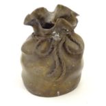 A late 19thC cast bronze modelled as a sack with a rope tie. Marked under. Approx. 6 3/4" high