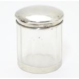A glass dressing table pot with silver top hallmarked Birmingham 1905 maker M bros. 2" high Please