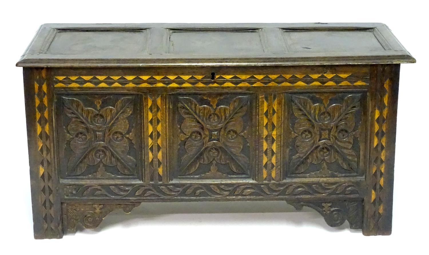 A 17thC oak three panel coffer with a moulded lid above carved panelling to the front with floral - Bild 4 aus 11