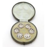 A cased set of 6 white metal buttons. Marked to reverse with Registered design no 352928. each