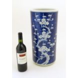 A Chinese blue and white large vase / stick / umbrella stand with prunus blossom detail. Approx.