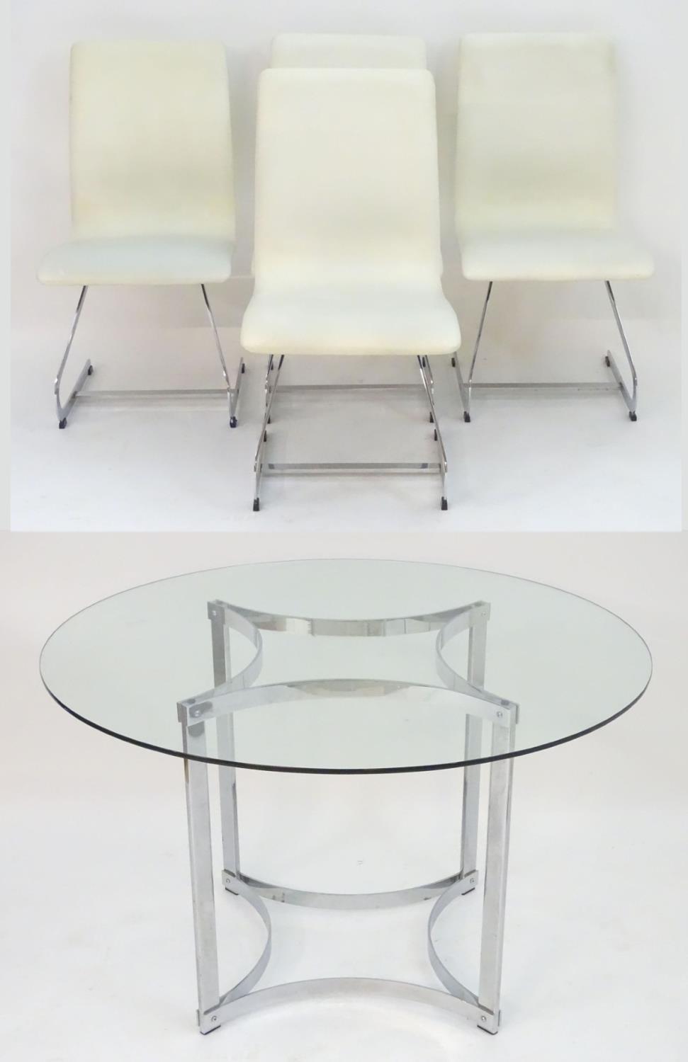 A mid / late 20thC glass top table with a chromed base and four cantilever dining chairs with