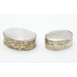 A silver pill box of oval form Hallmarked Sheffield 1998 together with a .925 silver pill box with