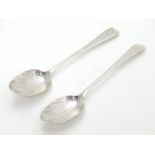 Two Geo III silver teaspoons with shell formed bowls and bright cut decoration to handles. one