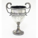 A silver pedestal trophy cup with twin handles. hallmarked Sheffield 1935 maker James Edward