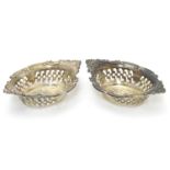 A pair of small silver boat-shaped pin dishes with pierced and C scroll decoration. Hallmarked