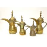 Four Middle Eastern brass Dallah coffee pots of varying sizes with impressed and banded detail.