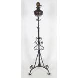 A wrought Iron telescopic oil lamp with tripod legs. 58" unextended, 86" fully extended Please