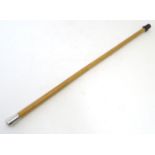 A walking cane with a malacca shaft and a white metal knop. Approx. 33" Please Note - we do not make