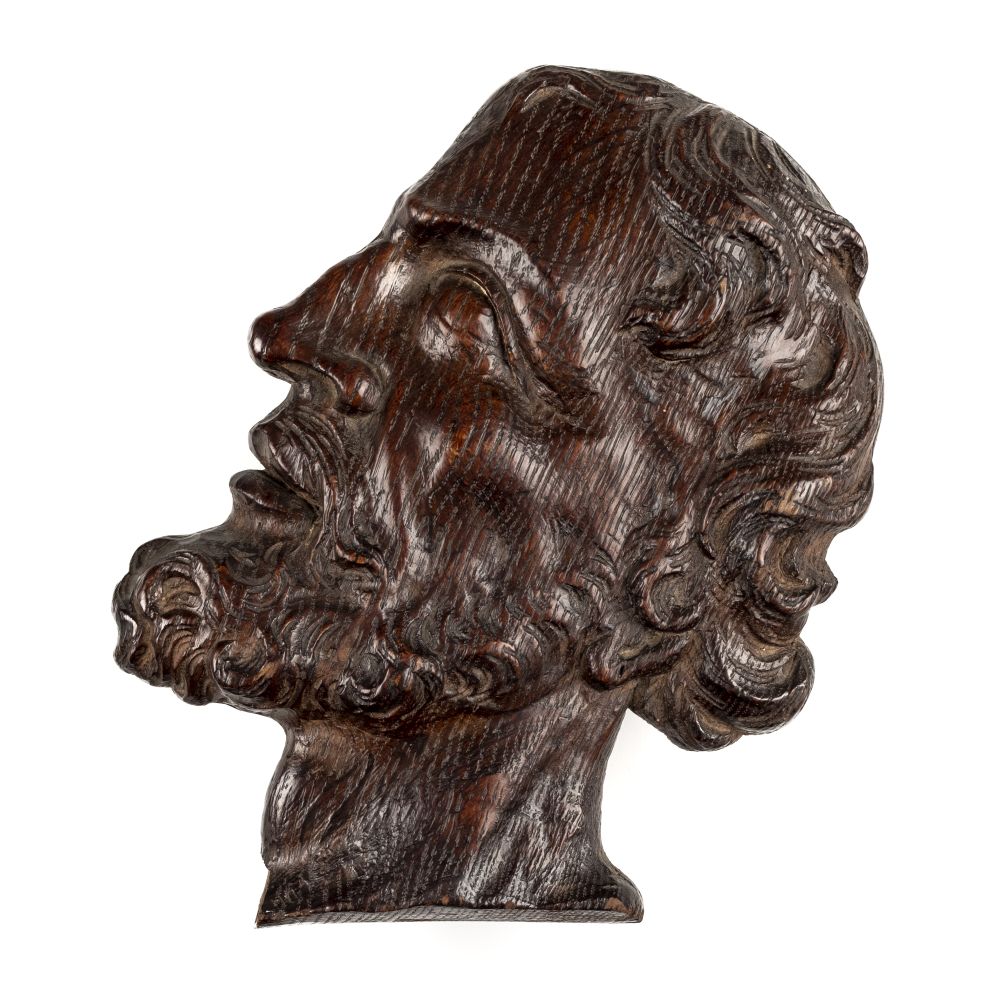 * Oak carving. A 17th century carved oak profile of a man