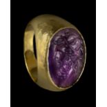 * Roman. A large Roman gold ring set with amethyst intaglio of Zeus