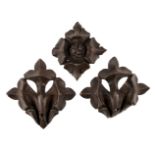 * Oak carvings. A pair of 18th century oak fleur de lys and rosette