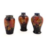 * Moorcroft. A pair of Moorcroft 'Pomegranate' pattern vases