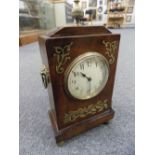 * Clock. A Regency style brass inlaid mahogany mantel clock