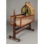 * Cradle. A Victorian mahogany and canework rocking cradle,