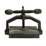 * Bookpress. A cast iron bookpress, finished in black, with brass handle ends & finial
