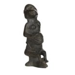 * African Carving. A 20th century hardstone fertility figure and shield