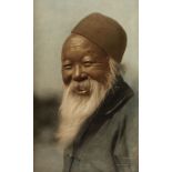 * China. Smiling face of an old man, hand-coloured carbon print, c. 1920s