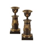 PAIR OF REGENCY PATINATED AND PARCEL GILT BRONZE CANDLESTICKS