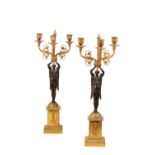 PAIR OF GILT AND PATINATED BRONZE THREE LIGHT FIGURAL CANDELABRA IN EMPIRE TASTE