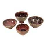 •DENIS MOORE (1908-1977) FOR GREEN DENE POTTERY: FOUR STONEWARE FOOTED BOWLS