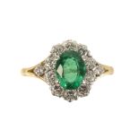 AN 18 CARAT GOLD EMERALD AND DIAMOND RING