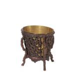 CARVED AND STAINED WOOD AND BRASS FITTED JARDINIERE STAND IN BLACK FOREST STYLE