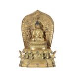 GILT-BRONZE FIGURE OF BUDDHA SHAKYAMUNI ON A STEPPED THRONE, TIBET, 16TH CENTURY OR LATER