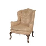 CARVED AND STAINED WOOD AND UPHOLSTERED WING ARMCHAIR