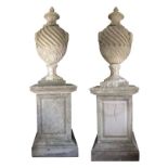 PAIR OF SUBSTANTIAL AND IMPOSING STONE COMPOSITION GARDEN URNS ON PLINTHS